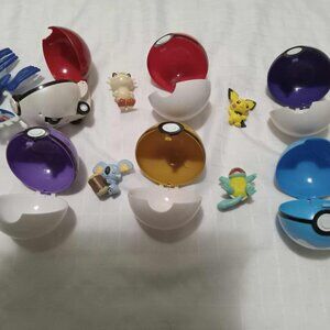 6 Pokemon pokeballs and figurines